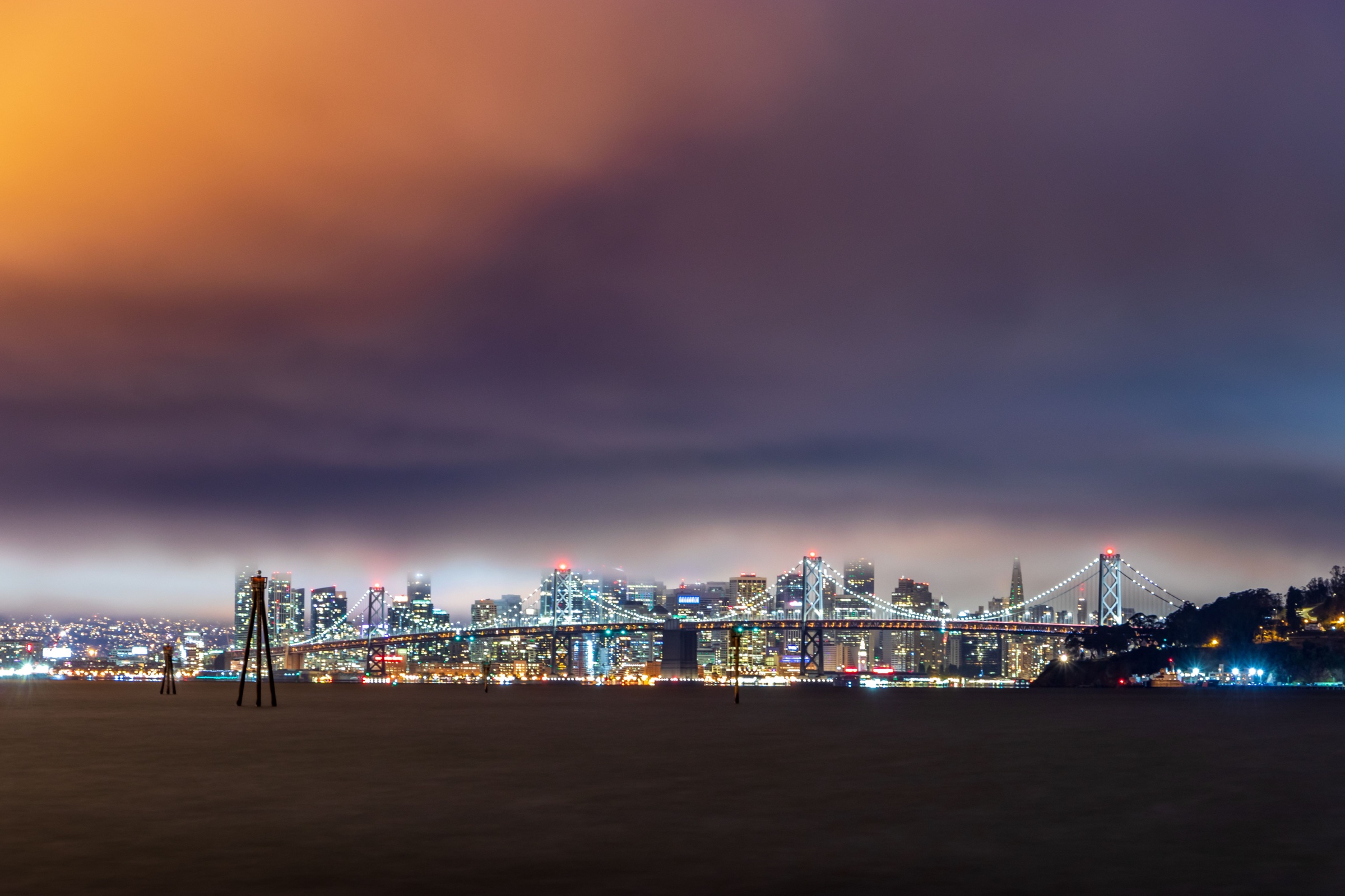Bay Bridge and San Francisco skyline illuminated at night